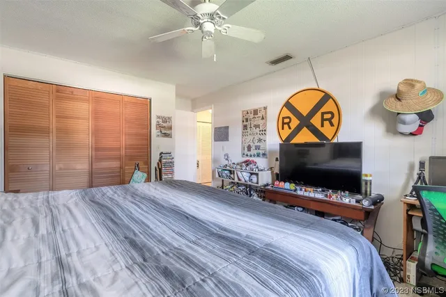 a bedroom with a bed and a flat screen tv