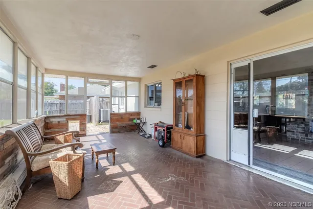 a living room with furniture and large windows