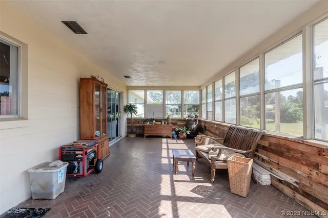 a living room with furniture and large windows