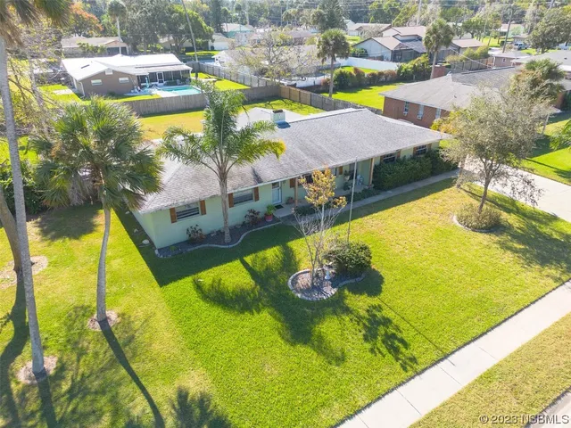 a view of a swimming pool with a yard