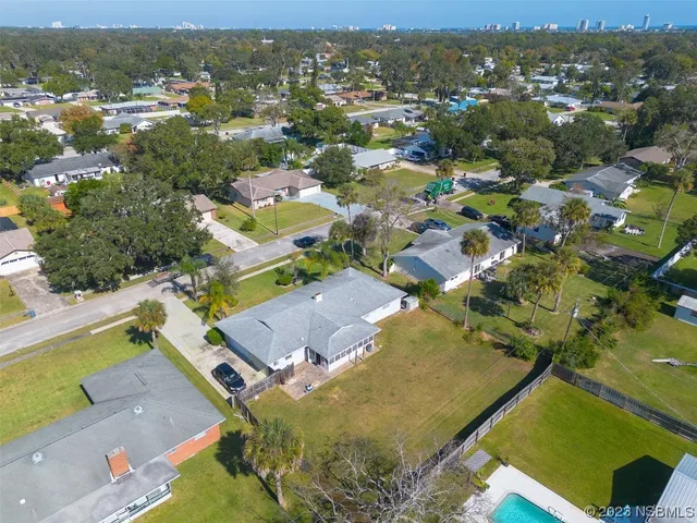 an aerial view of residential houses with outdoor space