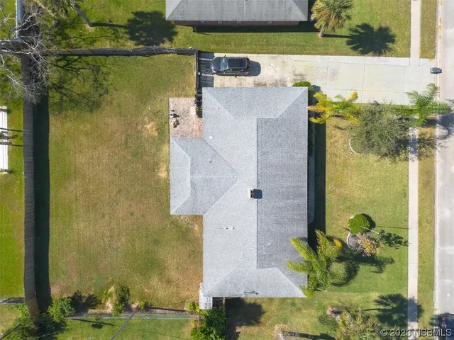 an aerial view of a house with a yard