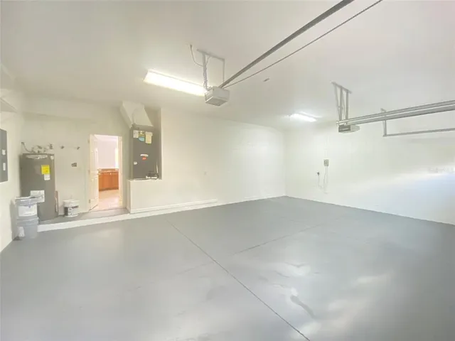 a view of a yard in front of a house with a large tree