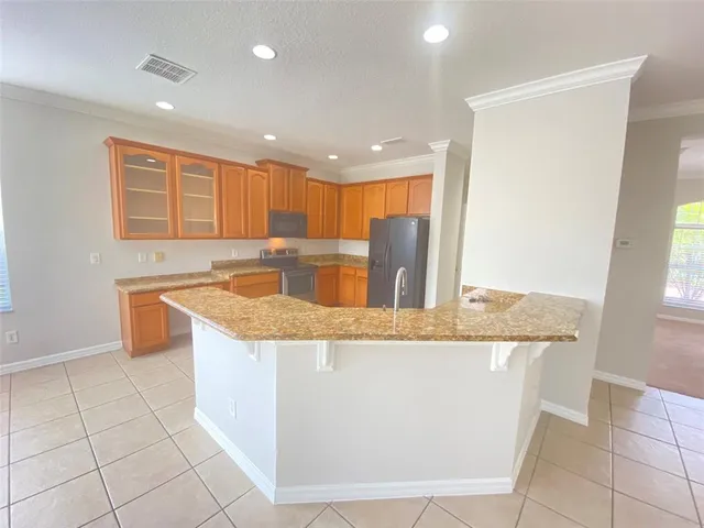 a kitchen with granite countertop sink and cabinets