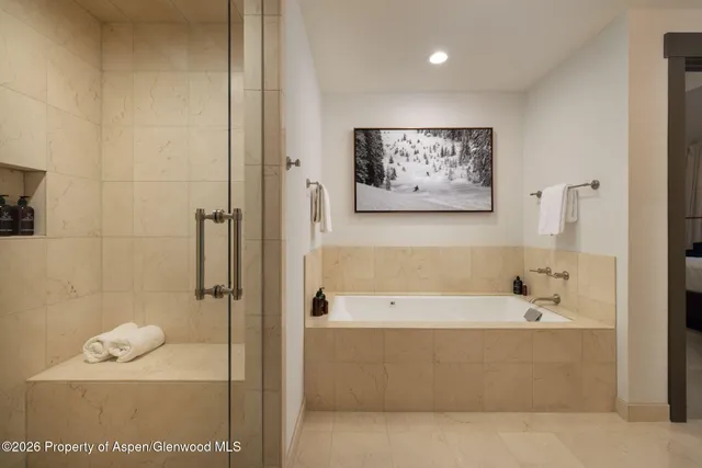 a bathroom with a bathtub and shower