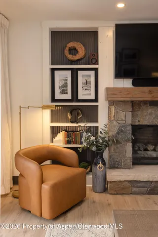 a living room with furniture a flat screen tv and a fireplace