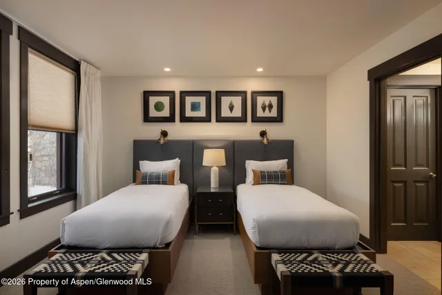 a bedroom with furniture and a mirror