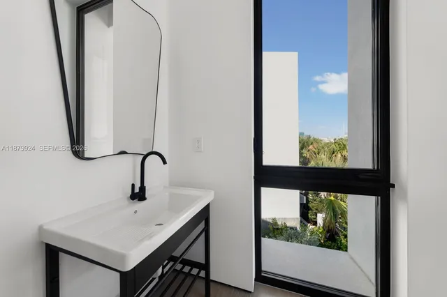 a roof deck with couches and potted plants with sky view
