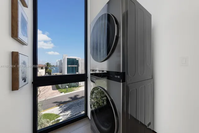 a roof deck with couches and potted plants