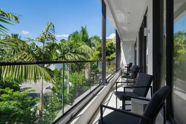 a view of balcony with lots of green space