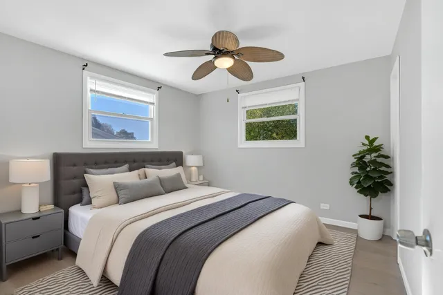 a bedroom with bed and a potted plant