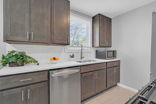 a room with a sink cabinets and window