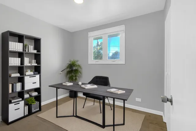 a view of a workspace room with furniture and closet