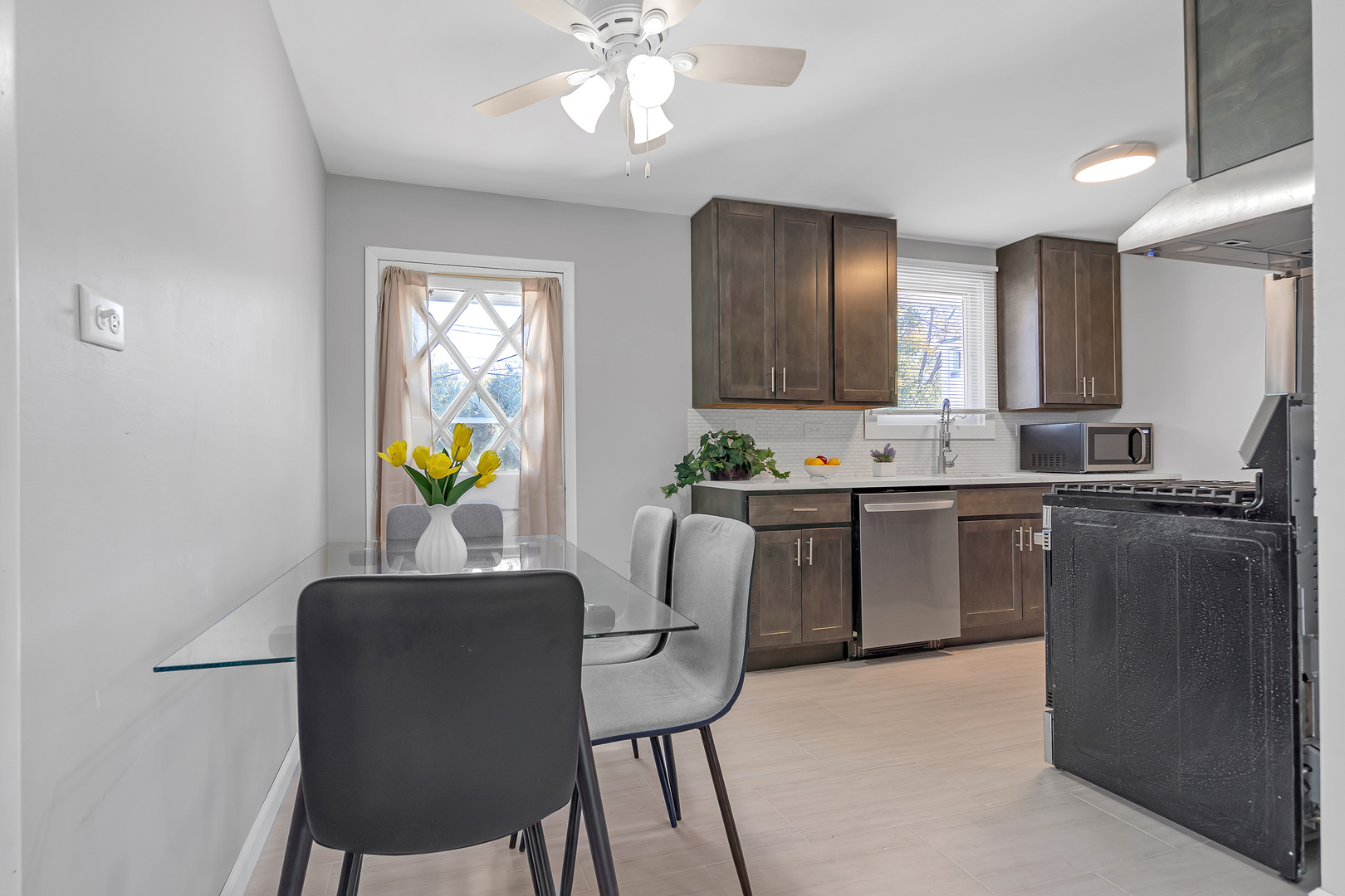 403 Arrowhead Trail Carol Stream, IL 60188 - Photo 9 of 22 a kitchen with a table chairs and a chandelier