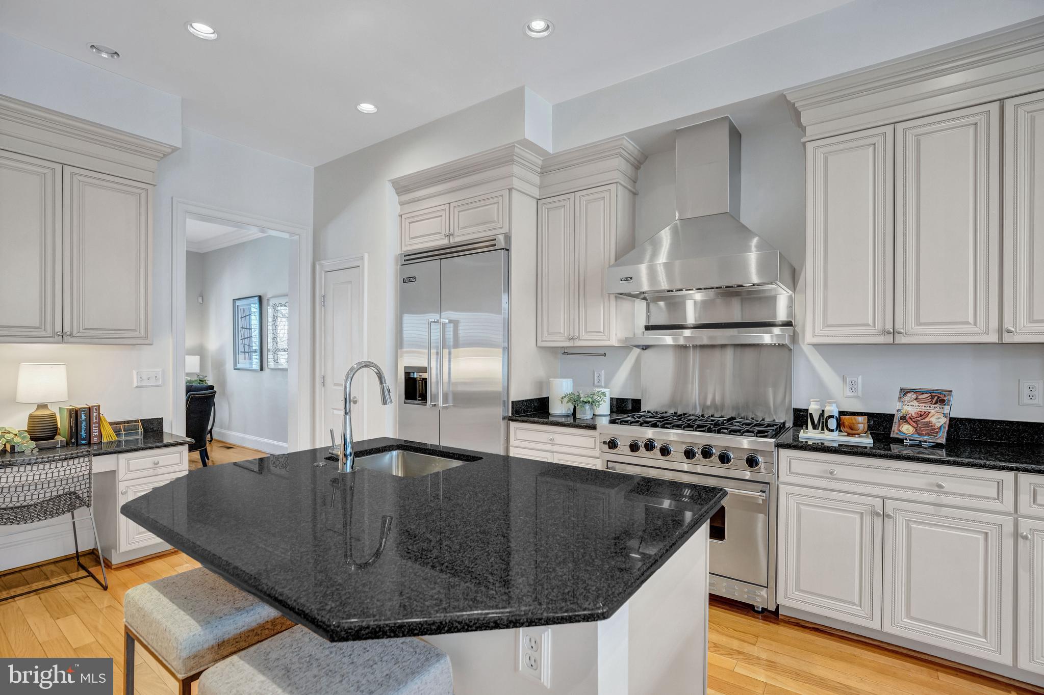 1820 Carpenter Road Alexandria, VA 22314 - Photo 17 of 80 a kitchen with kitchen island granite countertop a sink a stove and cabinets