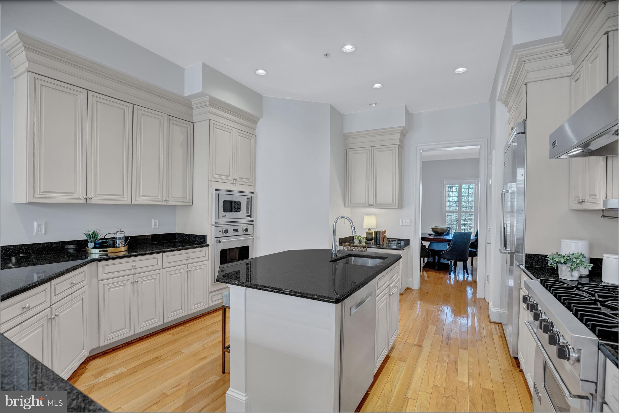 1820 Carpenter Road Alexandria, VA 22314 - Photo 23 of 80 a kitchen with granite countertop a sink a counter top space stainless steel appliances and cabinets