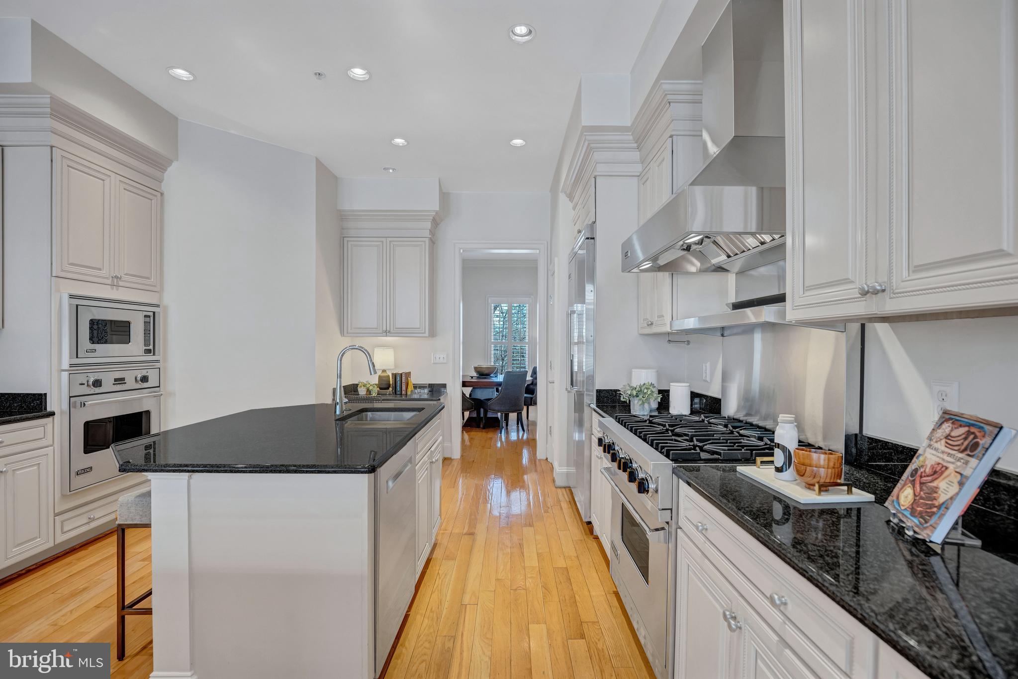1820 Carpenter Road Alexandria, VA 22314 - Photo 24 of 80 a kitchen with stainless steel appliances granite countertop a stove top oven a sink a counter space and cabinets