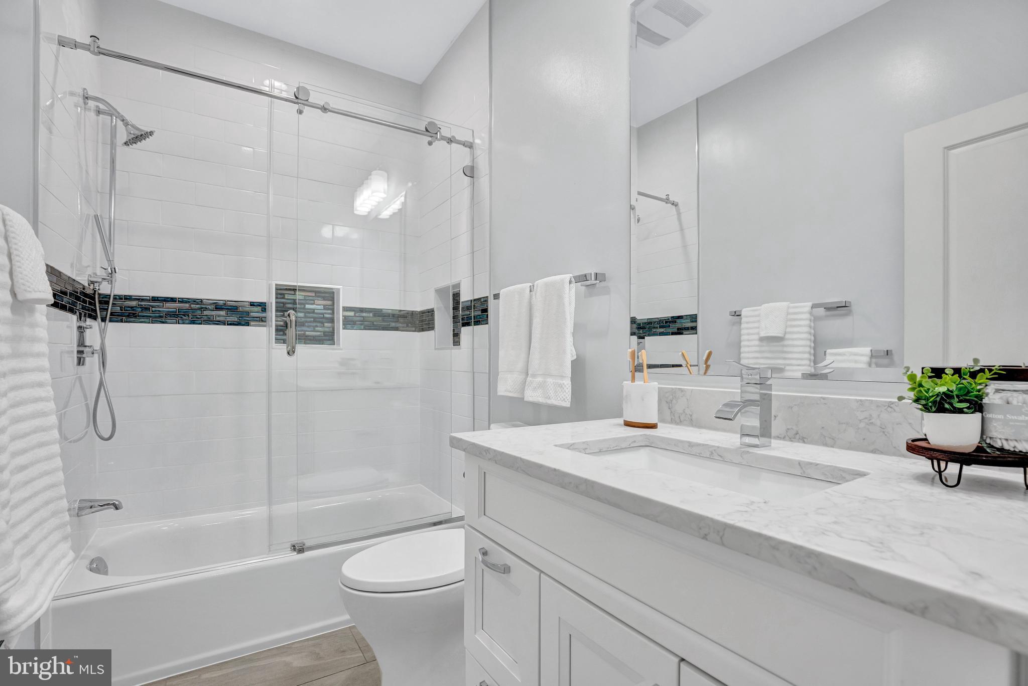 1820 Carpenter Road Alexandria, VA 22314 - Photo 40 of 80 a bathroom with a granite countertop sink a toilet and shower