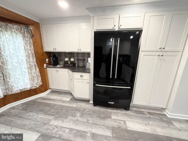 a kitchen with a table chairs and granite counter tops