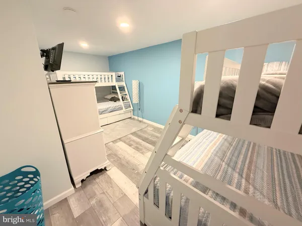 a bedroom with a bed and flat screen tv