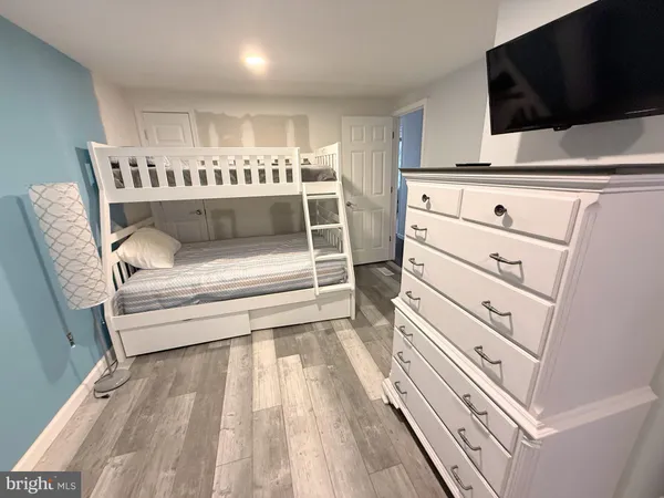 a bedroom with a bed and a large mirror