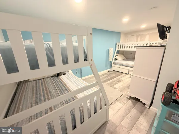 a bathroom with a sink a toilet a mirror and shower