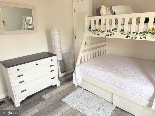 a view of a bedroom with furniture and window