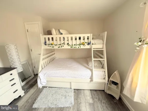 a view of a bedroom with furniture and window