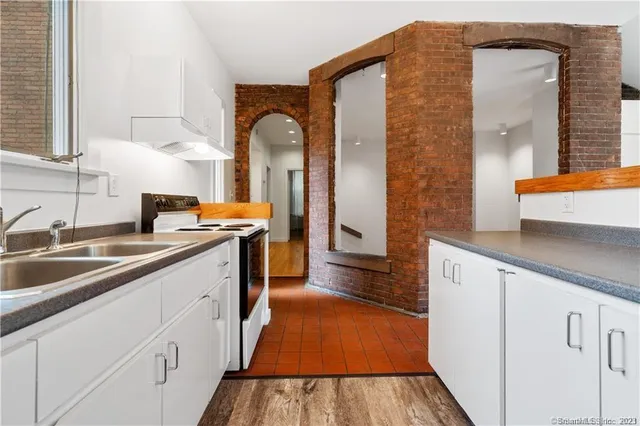 a kitchen with cabinets a sink and appliances