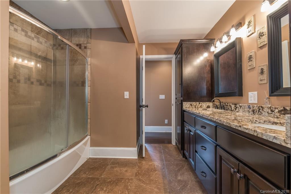 278 Bent Tree Drive Rutherfordton, NC 28139 - Photo 14 of 29 a bathroom with a double vanity sink and a mirror