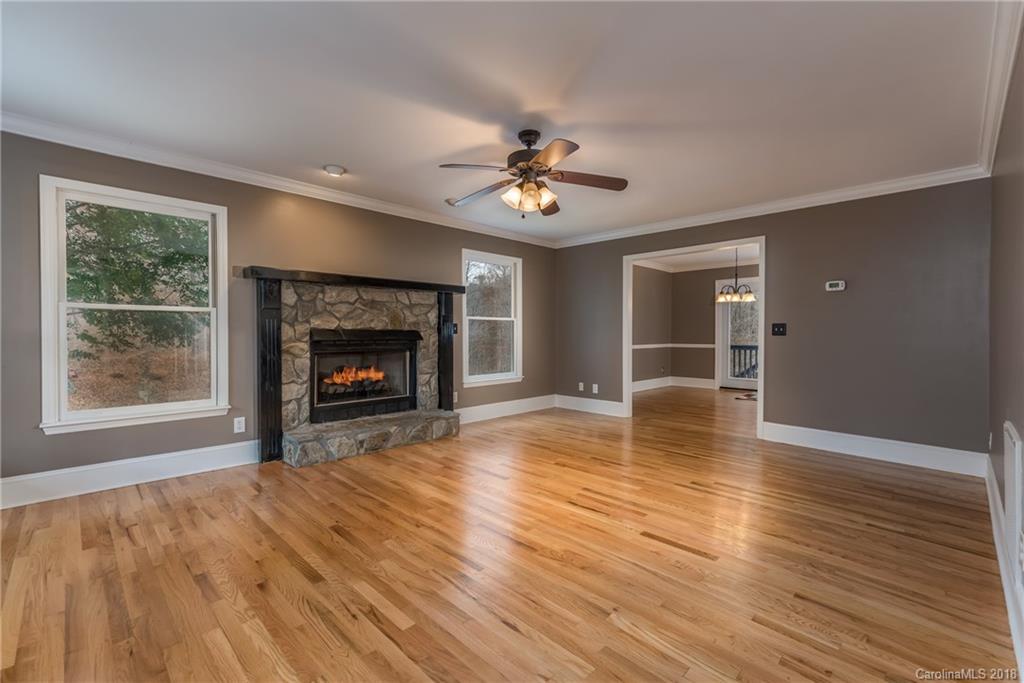 278 Bent Tree Drive Rutherfordton, NC 28139 - Photo 5 of 29 a view of an empty room with wooden floor fireplace and a window