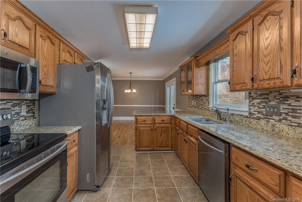 278 Bent Tree Drive Rutherfordton, NC 28139 - Photo 9 of 29 a kitchen with a sink stove and cabinets