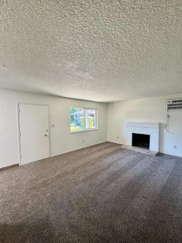 a view of empty room with a fireplace
