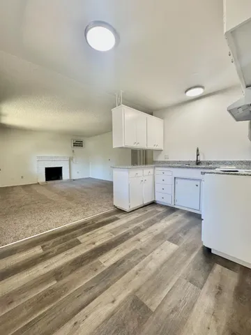 a view of a kitchen with a sink and cabinets