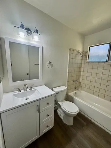 a bathroom with a double vanity sink toilet and shower