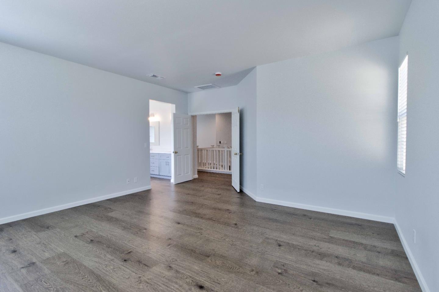 2715 Shellgate Circle Hayward, CA 94545 - Photo 24 of 47 a view of an empty room with wooden floor and a window