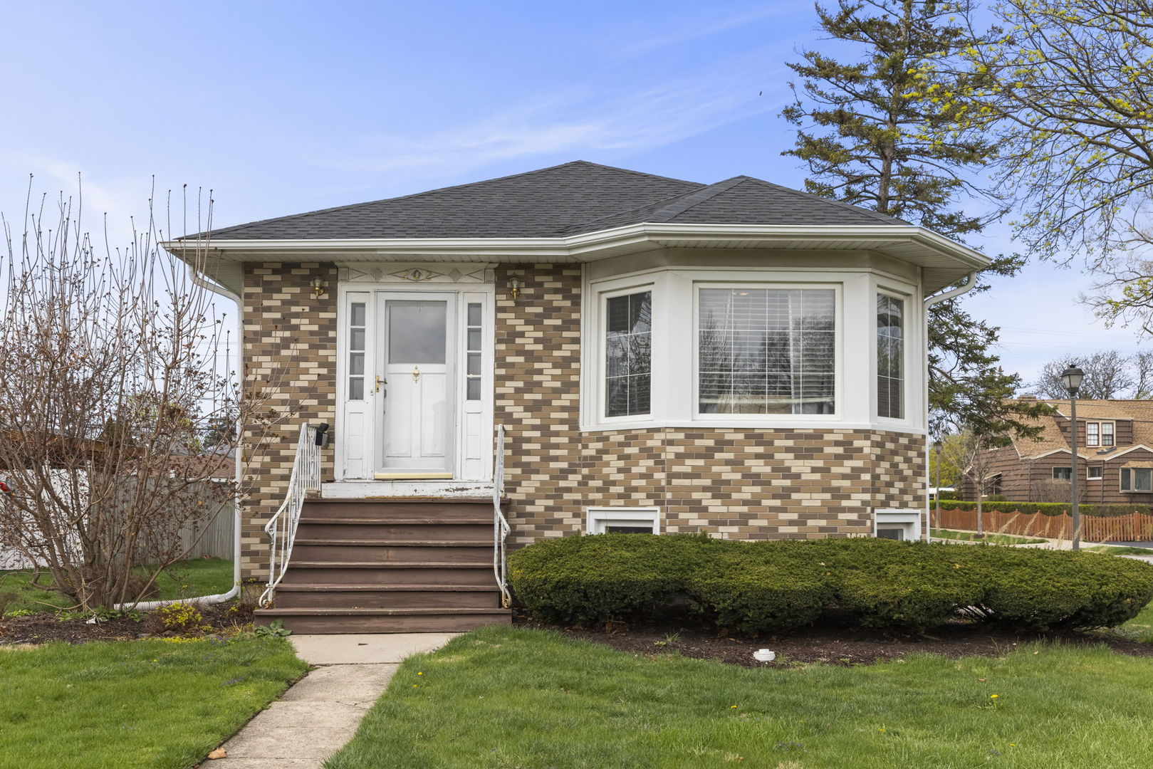 a front view of a house with a garden