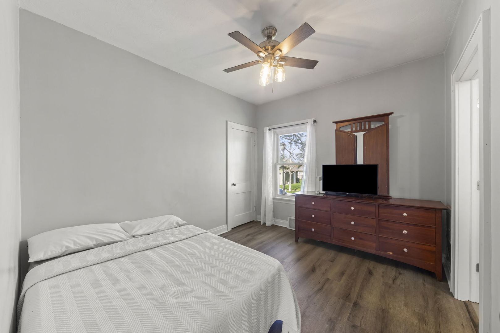 202 Pick Avenue Elmhurst, IL 60126 - Photo 16 of 26 a bedroom with a bed and a flat screen tv