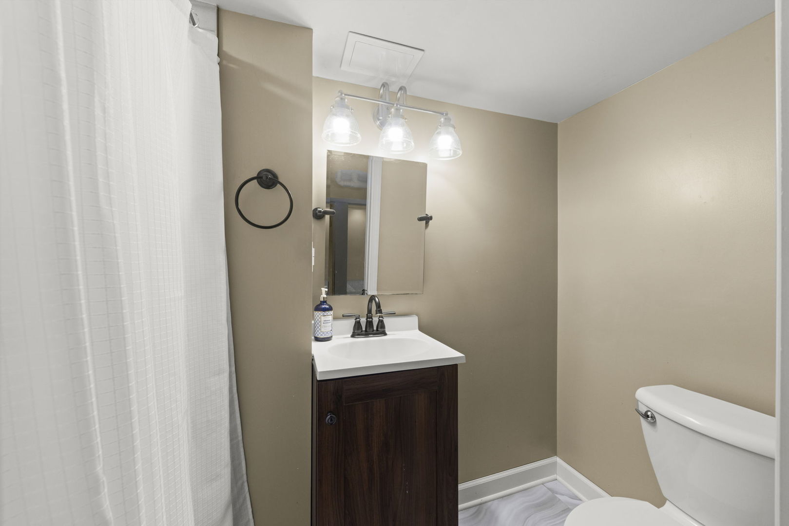 202 Pick Avenue Elmhurst, IL 60126 - Photo 18 of 26 a bathroom with a sink a toilet a mirror and shower