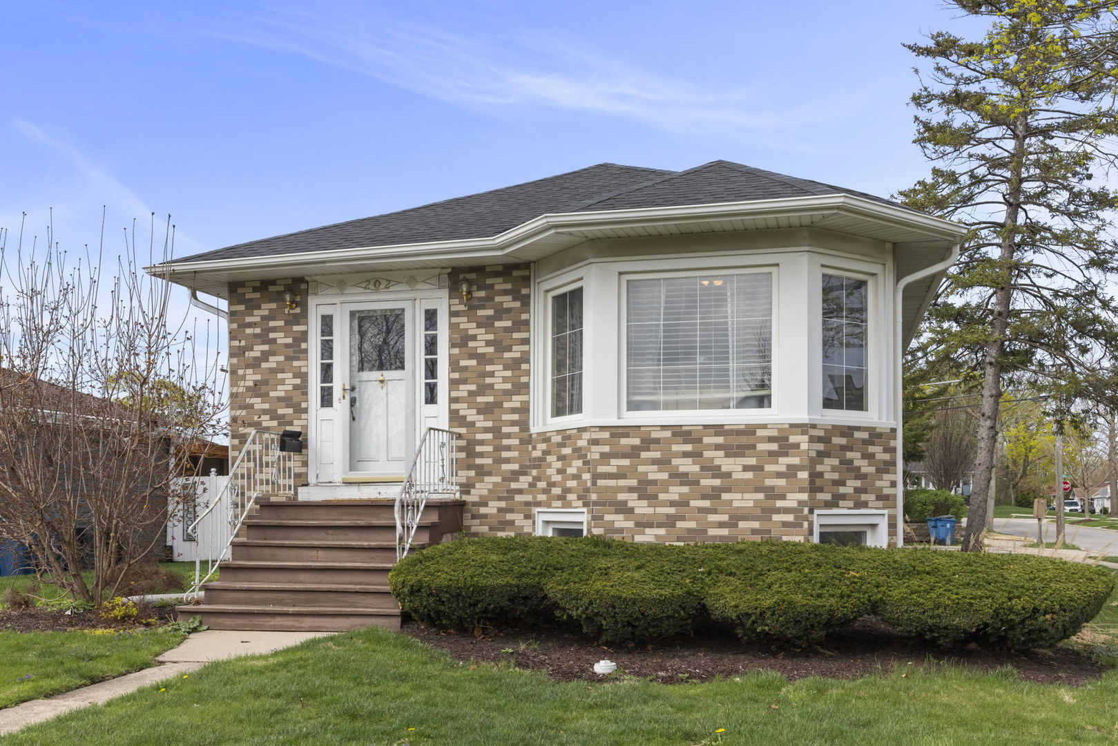 202 Pick Avenue Elmhurst, IL 60126 - Photo 2 of 26 a front view of a house with a garden