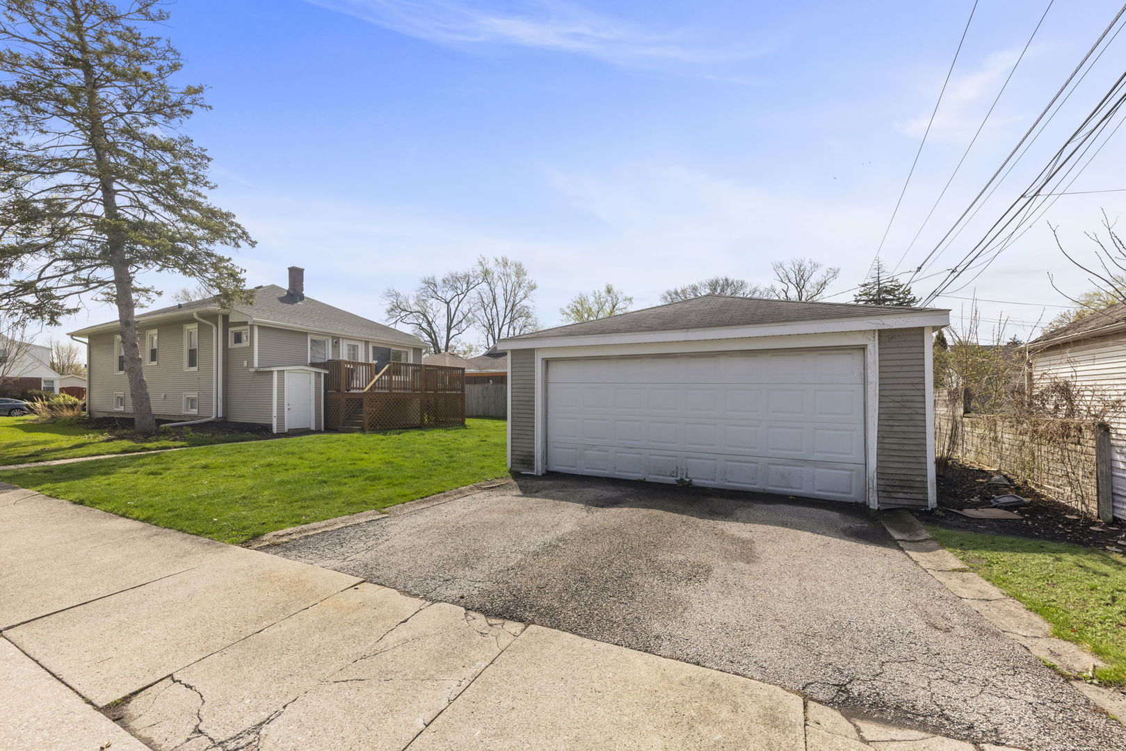202 Pick Avenue Elmhurst, IL 60126 - Photo 22 of 26 a view of a house with a big yard and large trees