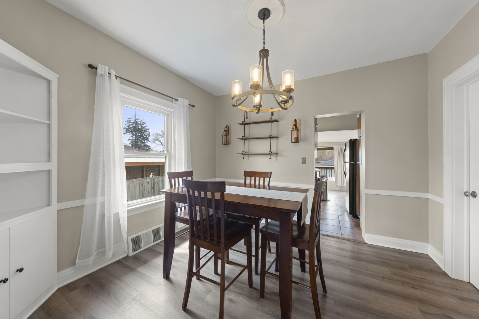 202 Pick Avenue Elmhurst, IL 60126 - Photo 7 of 26 a view of a dining room with furniture window and wooden floor