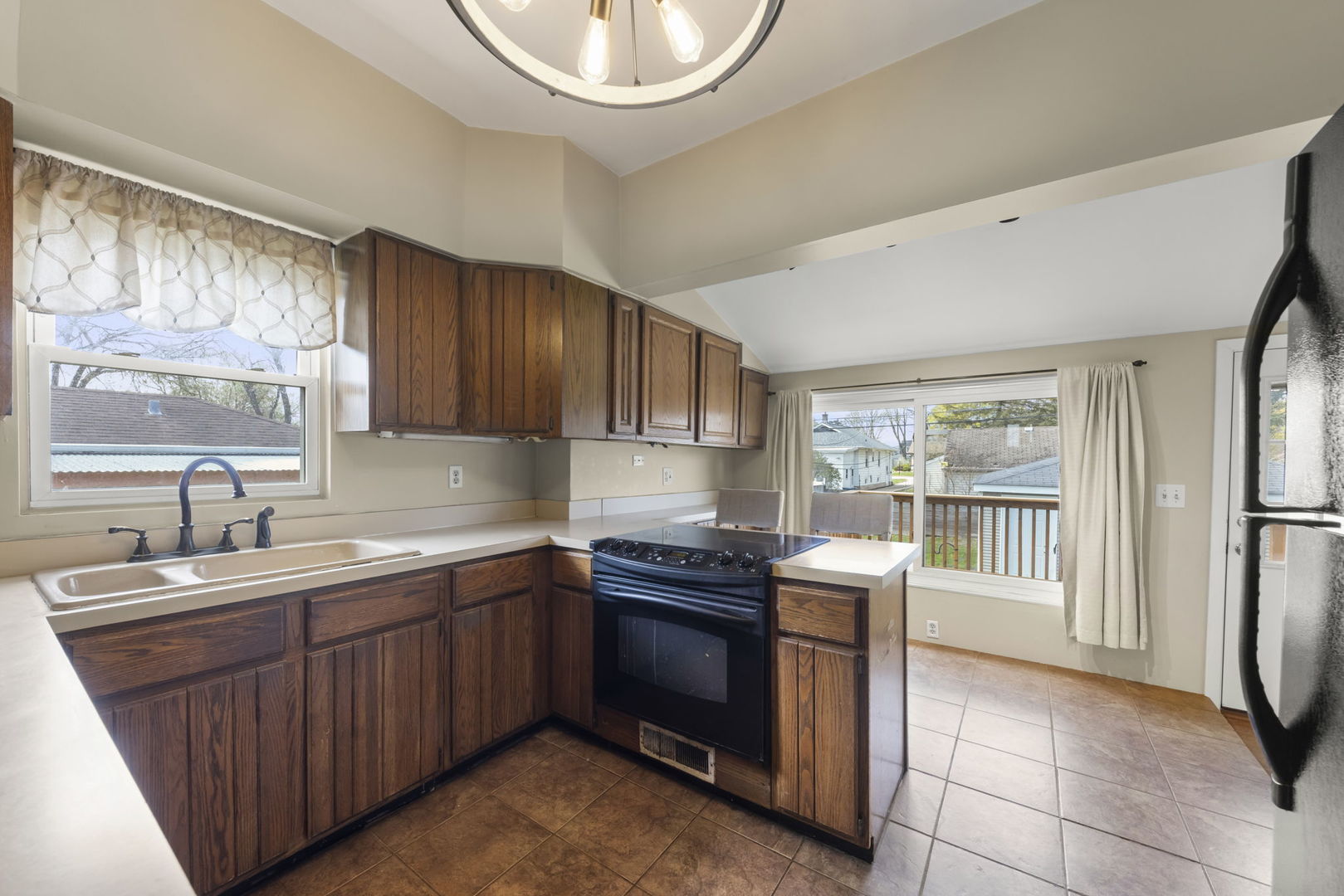202 Pick Avenue Elmhurst, IL 60126 - Photo 9 of 26 a kitchen with stainless steel appliances a sink a stove a refrigerator cabinets and a window