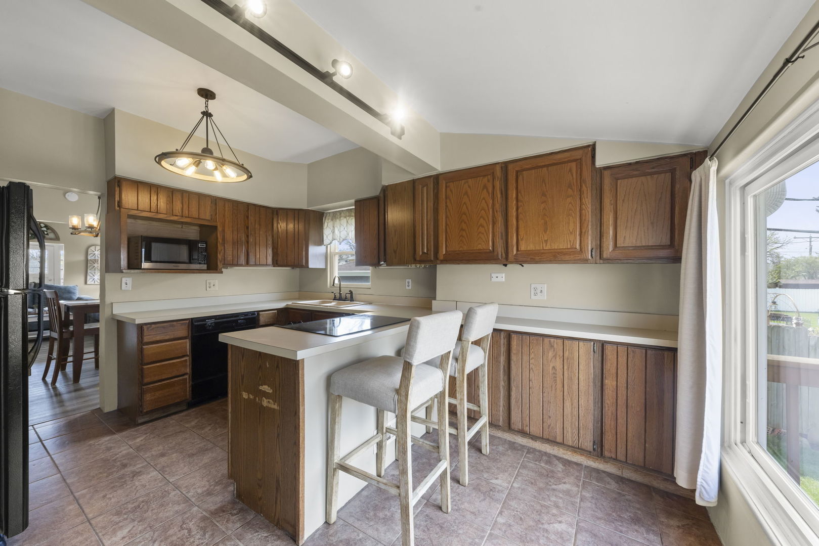 202 Pick Avenue Elmhurst, IL 60126 - Photo 10 of 26 a kitchen with stainless steel appliances granite countertop a stove top oven a sink dishwasher and a refrigerator with wooden cabinets