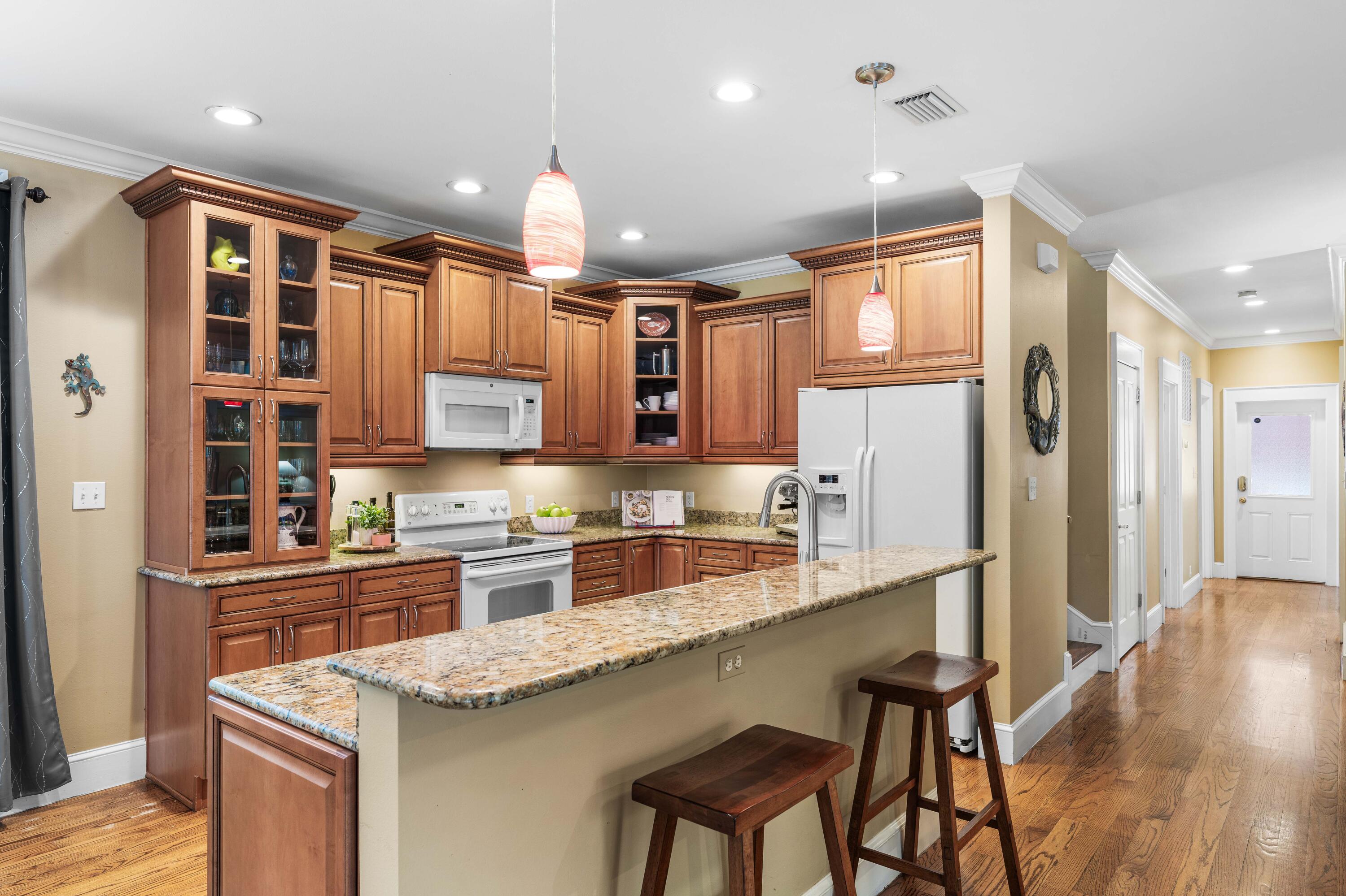 556 Little Canal Drive Santa Rosa Beach, FL 32459 - Photo 23 of 60 a kitchen with stainless steel appliances granite countertop a sink refrigerator and cabinets