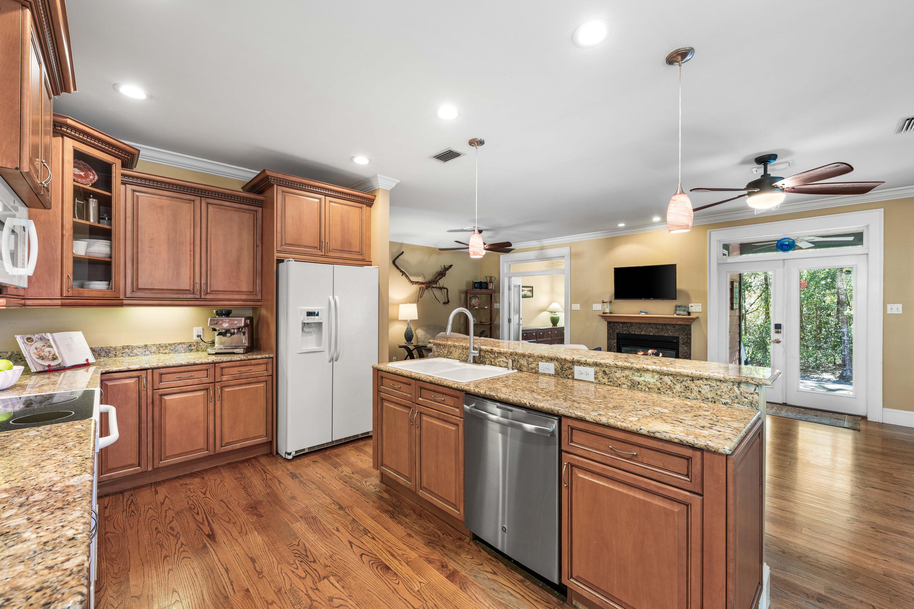 556 Little Canal Drive Santa Rosa Beach, FL 32459 - Photo 24 of 60 a kitchen with stainless steel appliances granite countertop a sink stove and refrigerator