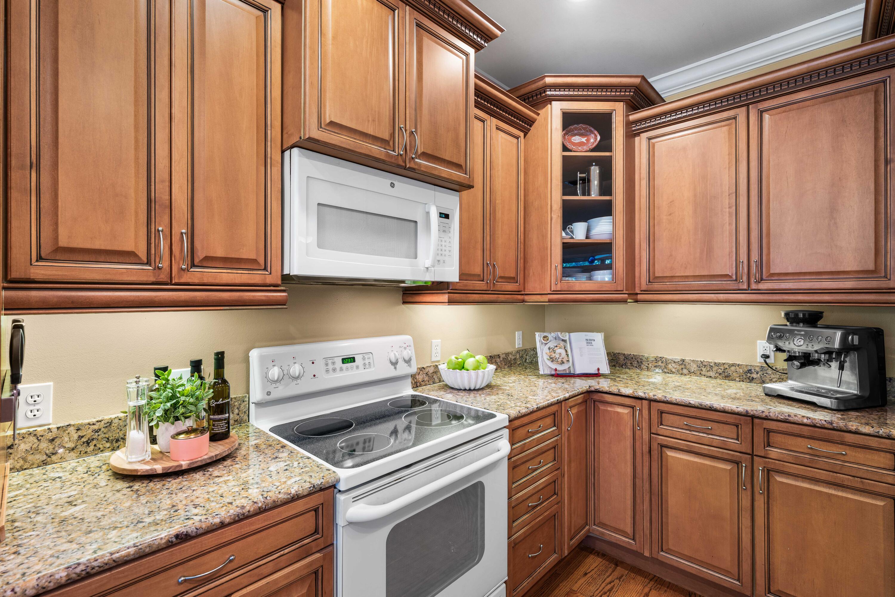 556 Little Canal Drive Santa Rosa Beach, FL 32459 - Photo 25 of 60 a kitchen with stainless steel appliances granite countertop a sink a stove and cabinets
