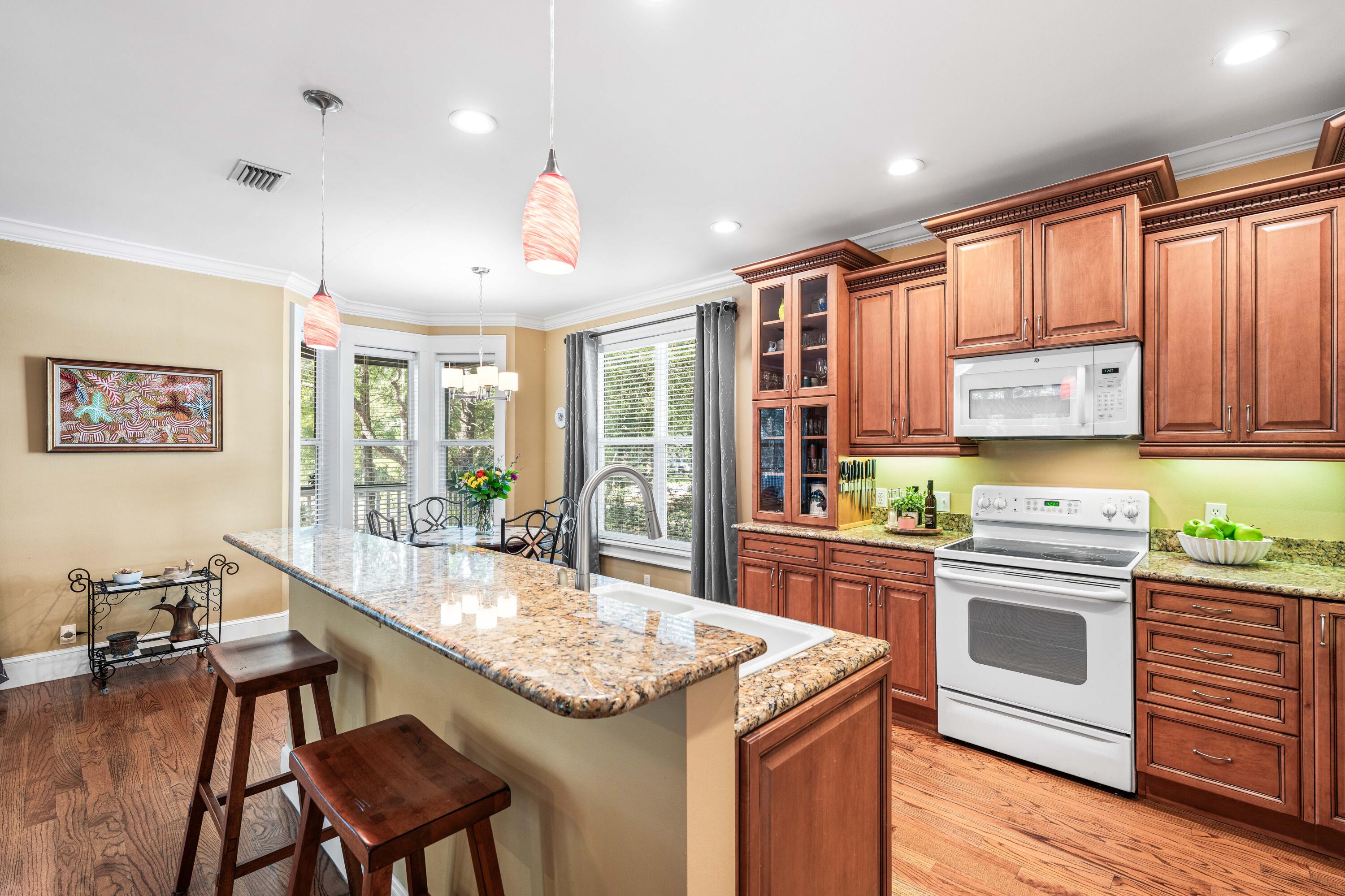 556 Little Canal Drive Santa Rosa Beach, FL 32459 - Photo 27 of 60 a kitchen with stainless steel appliances granite countertop a stove and chairs