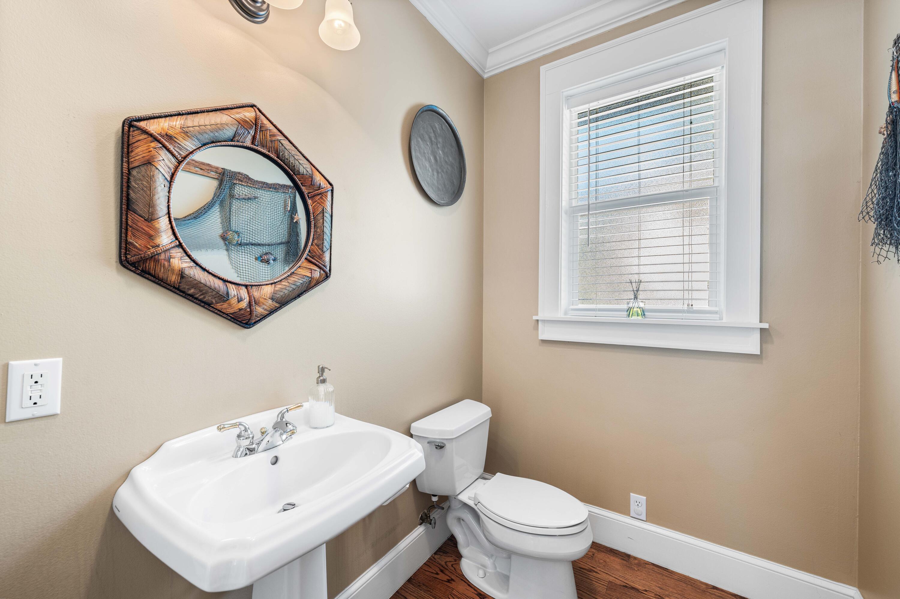 556 Little Canal Drive Santa Rosa Beach, FL 32459 - Photo 30 of 60 a bathroom with a toilet a sink and a mirror