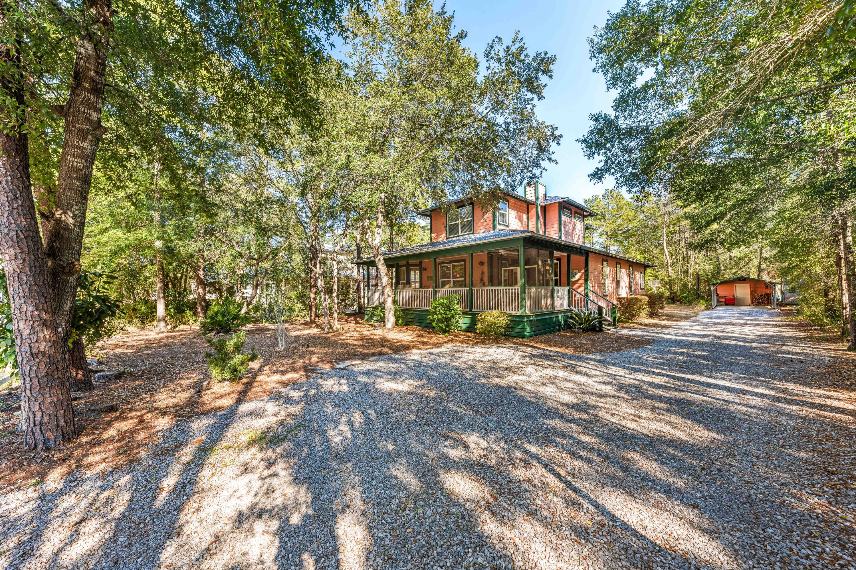 556 Little Canal Drive Santa Rosa Beach, FL 32459 - Photo 6 of 60 a front view of a building with trees